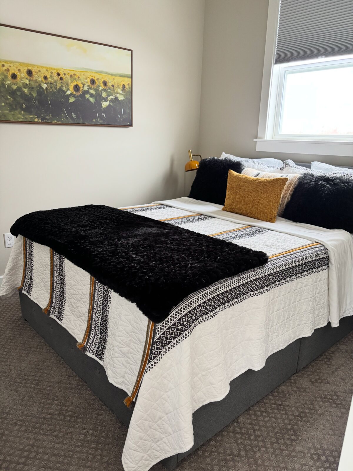 Comfortable bedroom with warm gold accents at The Carriage House