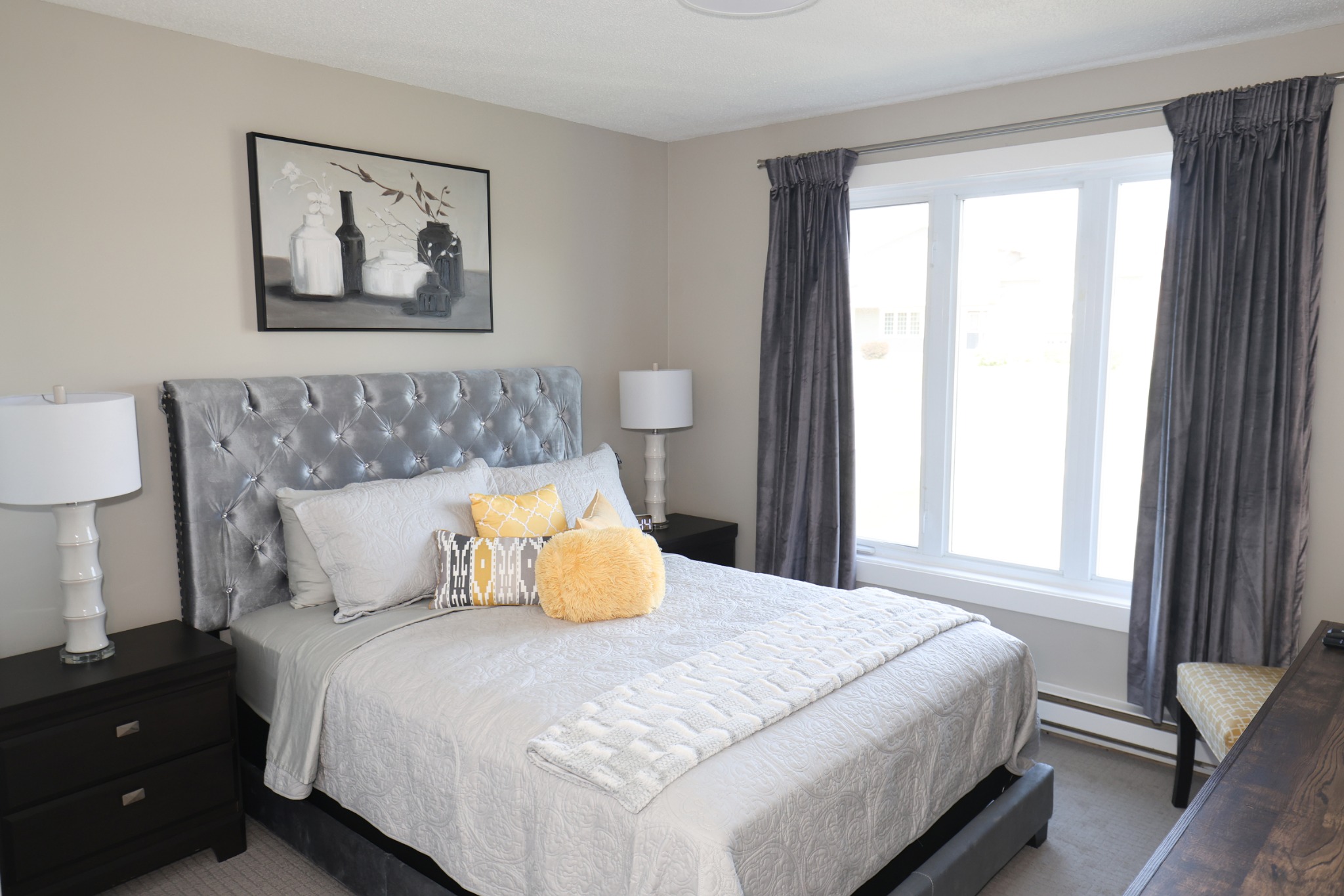 Bright bedroom with gold accents at Doyle's Haven